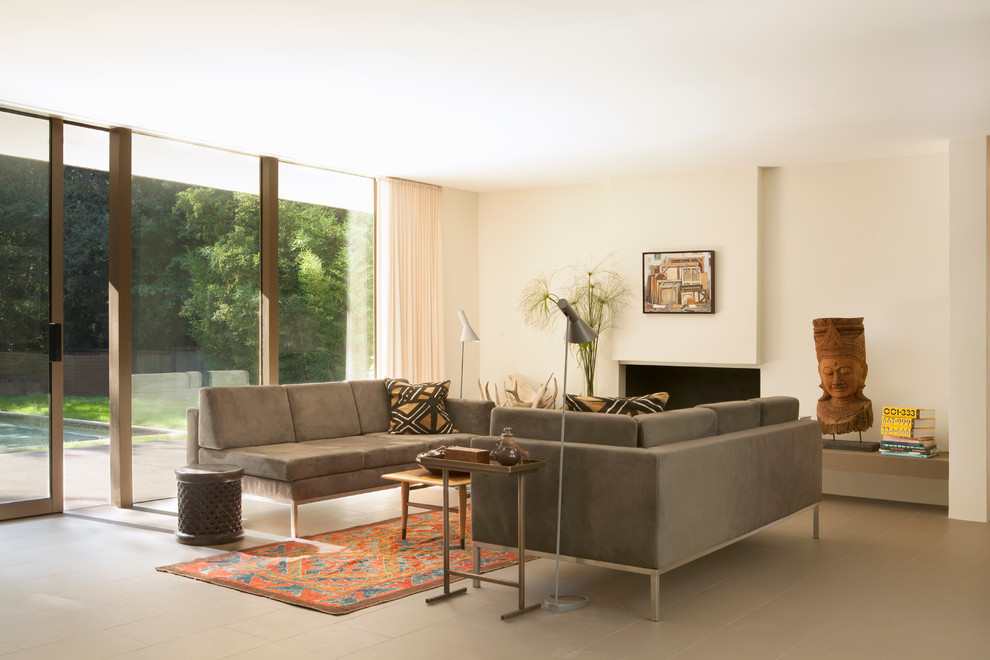 Example of a 1960s porcelain tile and beige floor living room design in Los Angeles with white walls and a standard fireplace