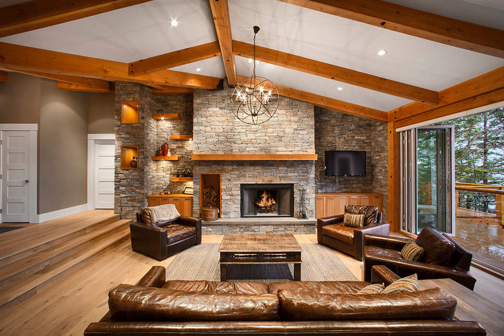 Photo of a contemporary living room in Vancouver with a stone fireplace surround.