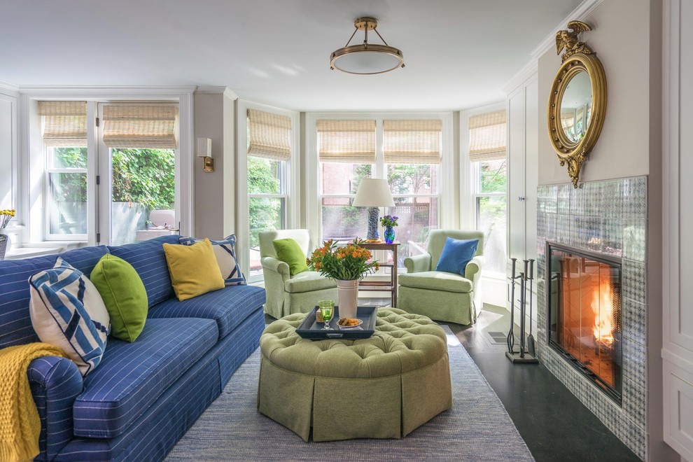 Example of a classic open concept black floor living room design in Boston with beige walls, a standard fireplace and a tile fireplace