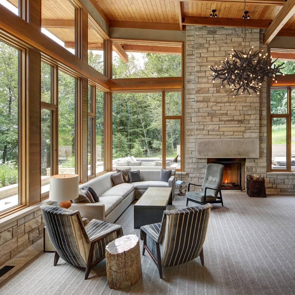 Example of a transitional carpeted living room design in Milwaukee with a standard fireplace and a stone fireplace