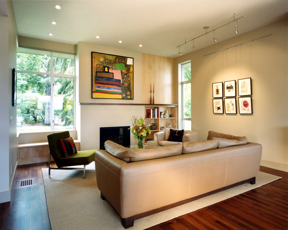 Trendy living room photo in Seattle with beige walls and a standard fireplace