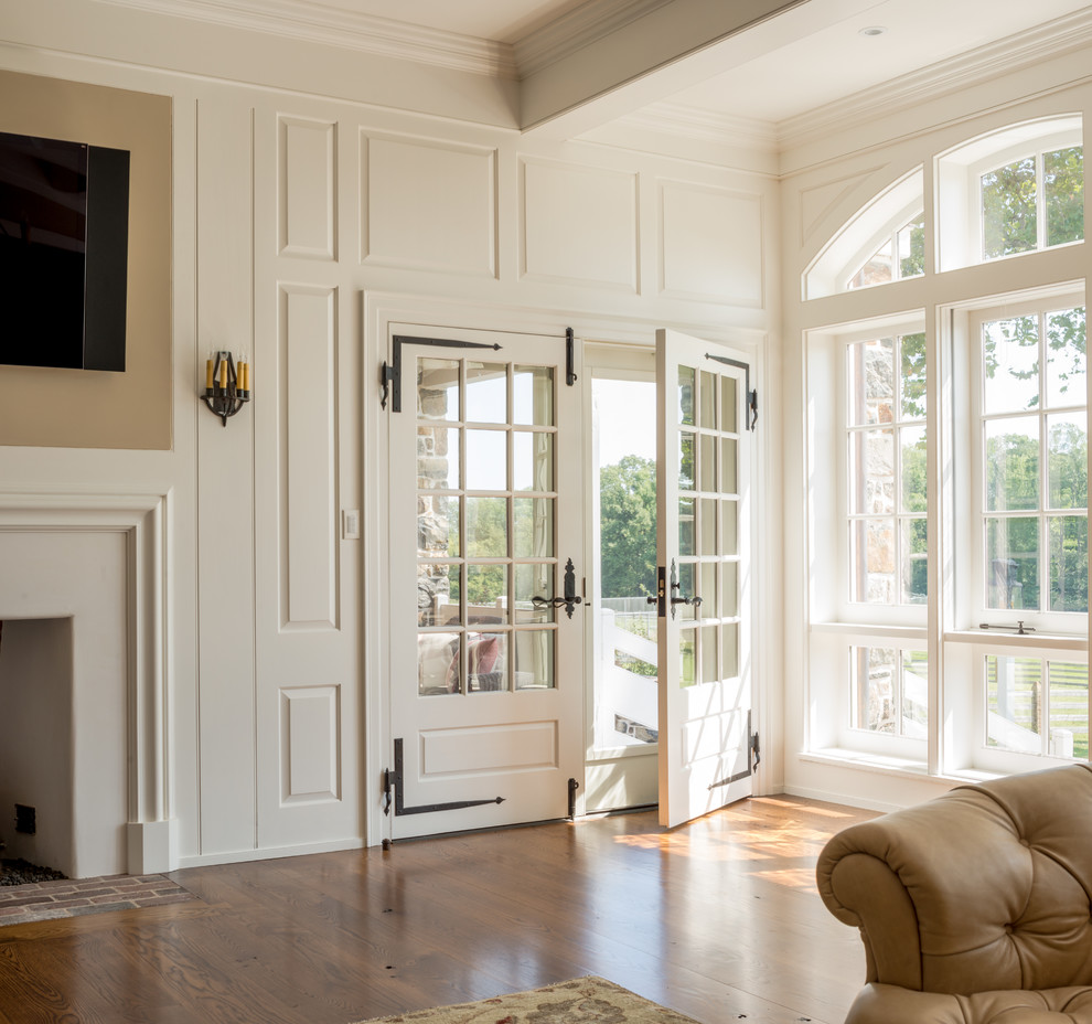 Geräumiges, Offenes Klassisches Wohnzimmer mit beiger Wandfarbe, Kamin, verputzter Kaminumrandung und TV-Wand in Philadelphia