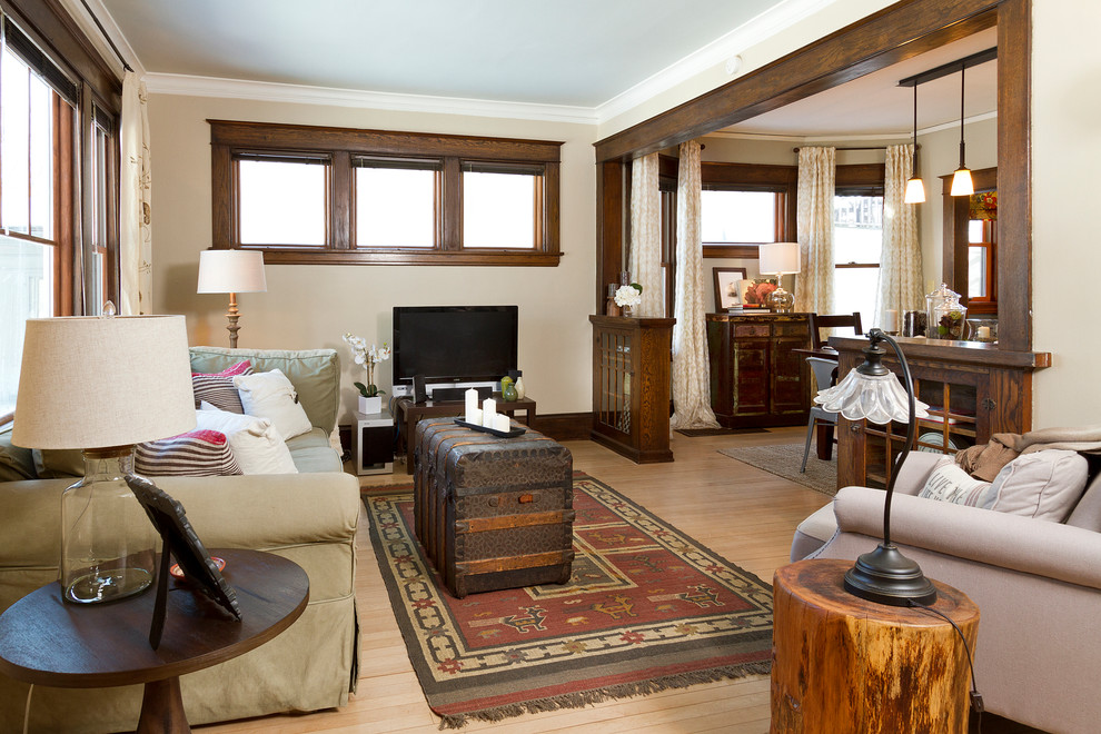 Example of a mid-sized arts and crafts open concept light wood floor living room design in Minneapolis with beige walls