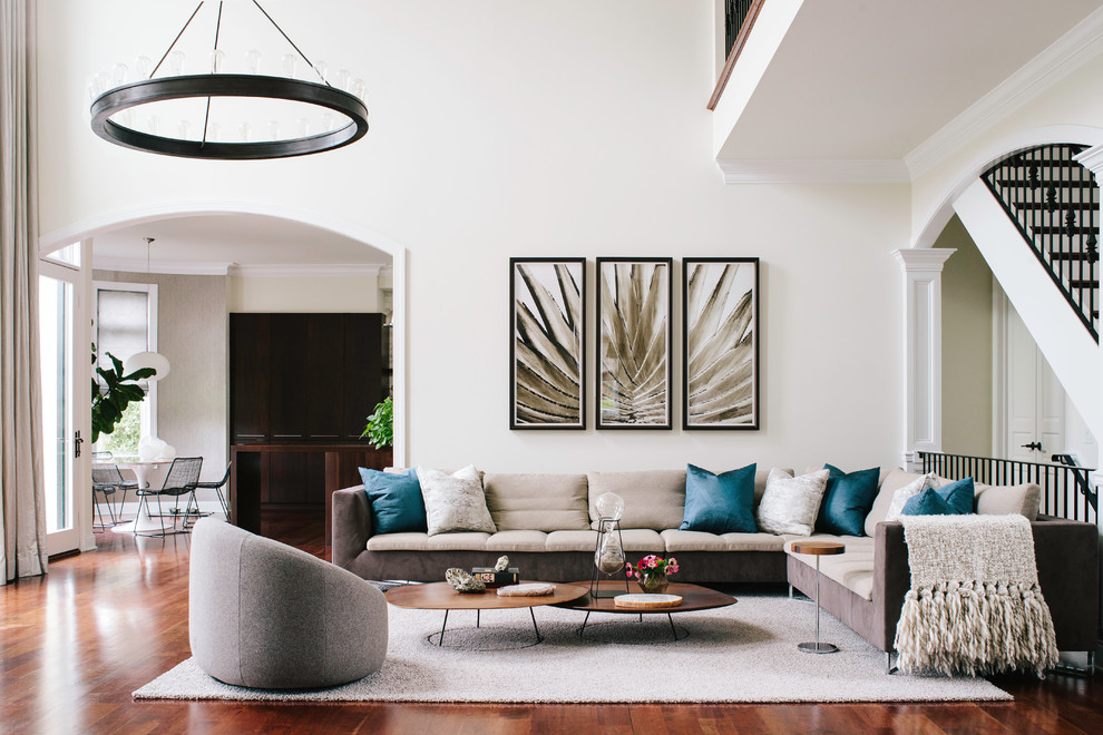 Classic open plan living room in Philadelphia with beige walls, medium hardwood flooring and orange floors.