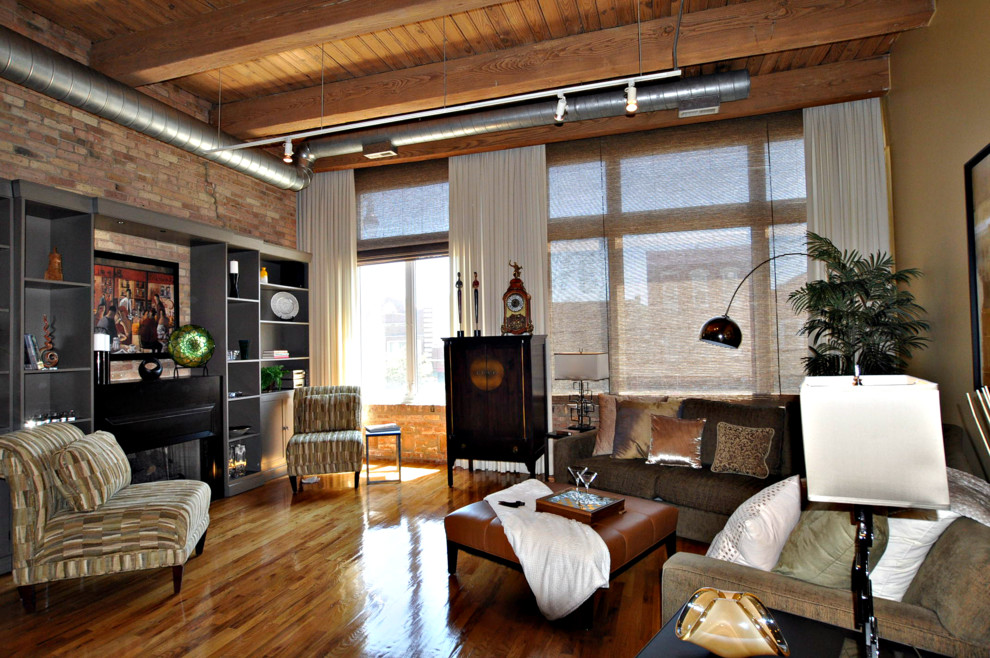 Immagine di un soggiorno industriale di medie dimensioni e stile loft con pavimento in legno massello medio, camino classico e cornice del camino in intonaco