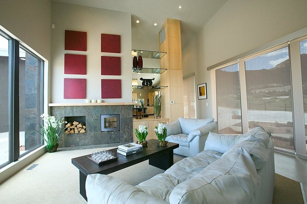 Photo of a large modern open plan living room in Denver with white walls, carpet, a hanging fireplace, a tiled fireplace surround and no tv.
