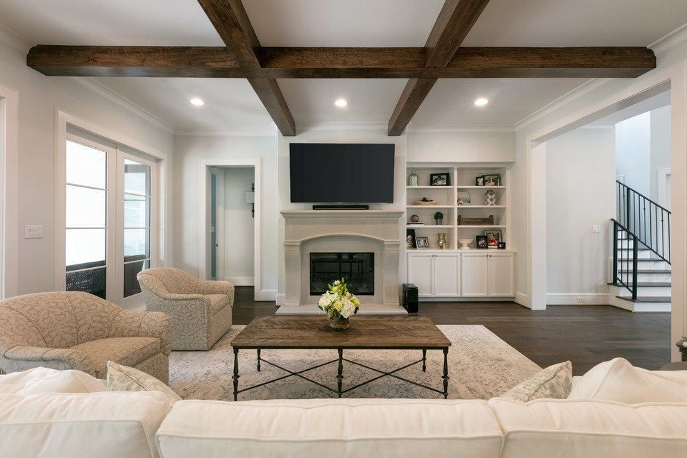 Inspiration for a large traditional open plan living room in Houston with white walls, medium hardwood flooring, a standard fireplace, a stone fireplace surround, brown floors and a wall mounted tv.