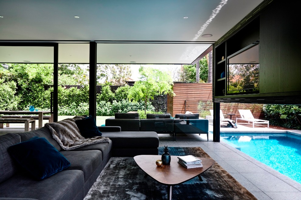 Medium sized contemporary open plan living room in Melbourne with limestone flooring and a built-in media unit.