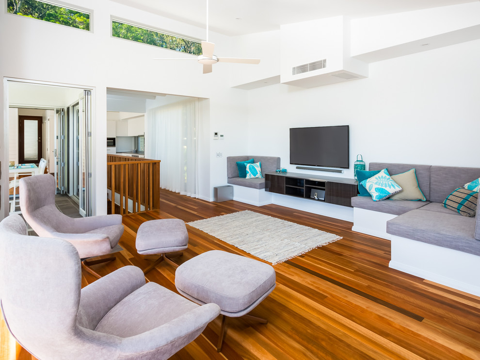Foto di un grande soggiorno contemporaneo aperto con pareti bianche, pavimento marrone, pavimento in legno massello medio e TV a parete