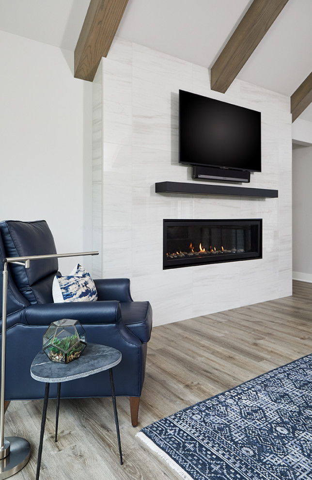 Design ideas for a traditional open plan living room in Grand Rapids with white walls, medium hardwood flooring, a ribbon fireplace, a tiled fireplace surround, a wall mounted tv and grey floors.