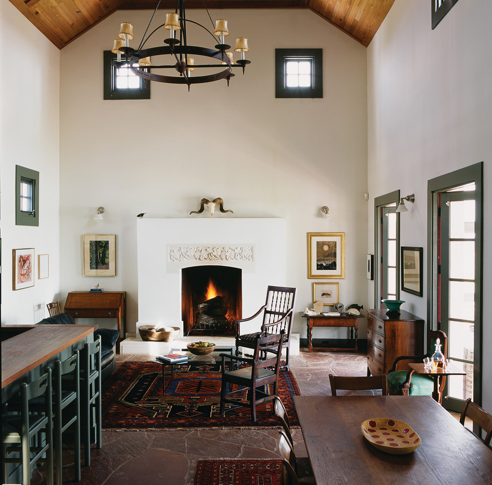 Photo of a farmhouse open plan living room in Austin with white walls, a standard fireplace and no tv.