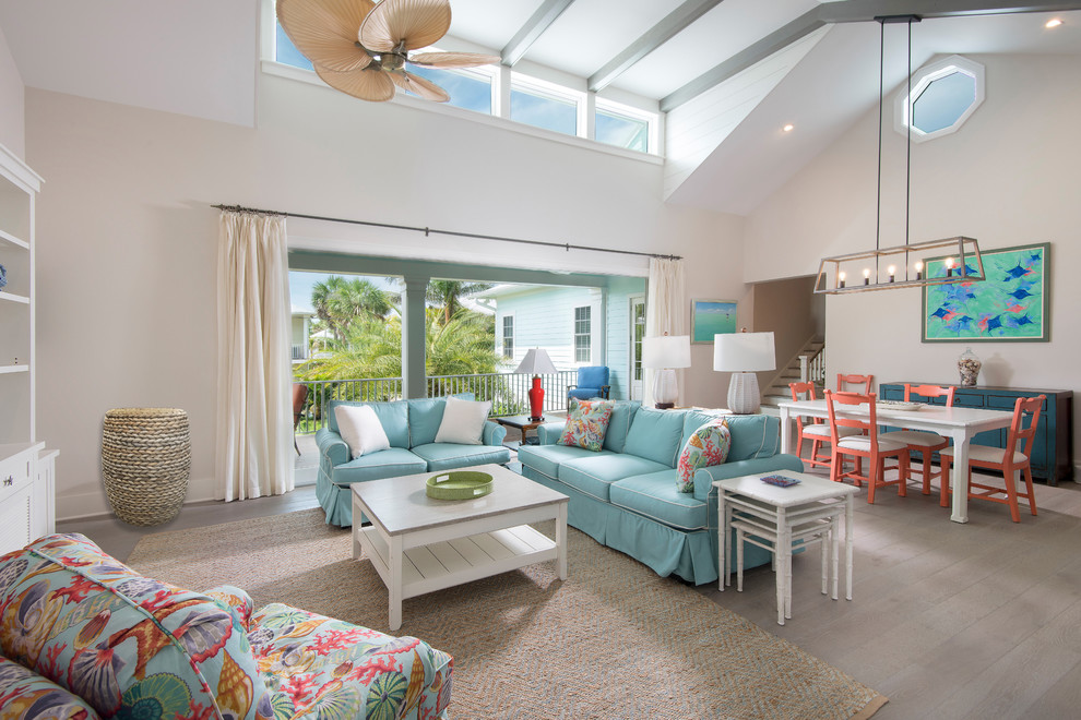 Example of a mid-sized beach style open concept light wood floor and beige floor living room design in Tampa with white walls and no fireplace