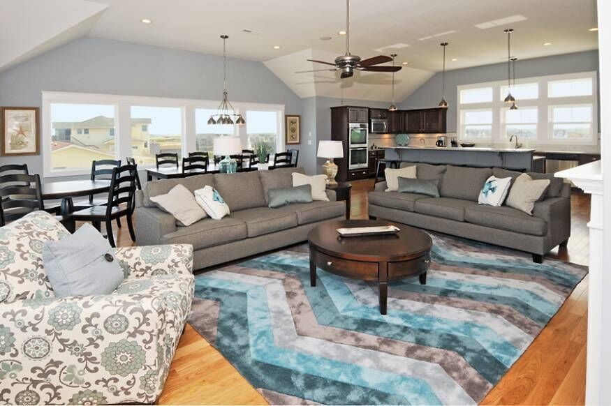 Design ideas for a medium sized classic formal and grey and teal open plan living room in Orange County with grey walls, medium hardwood flooring, a standard fireplace, a tiled fireplace surround and a wall mounted tv.