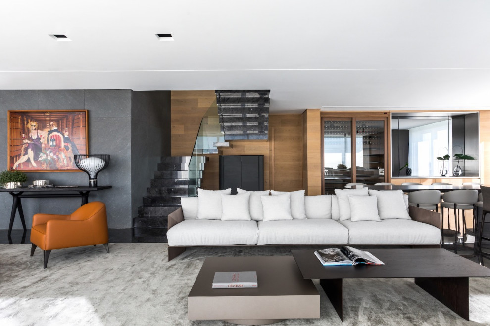 Пример оригинального дизайна: открытая гостиная комната в современном стиле с белыми стенами и черным полом