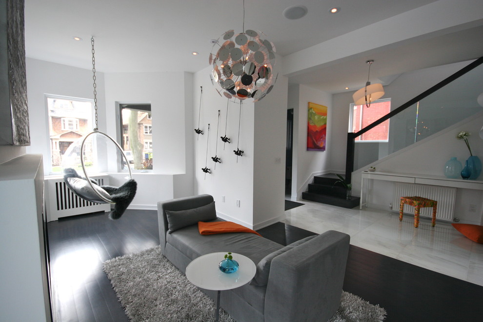 Minimalist black floor living room photo in Toronto with white walls