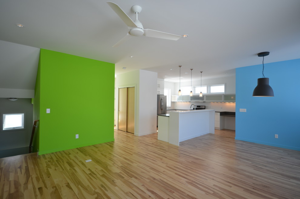 Inspiration for a modern open concept medium tone wood floor living room remodel in Minneapolis with green walls