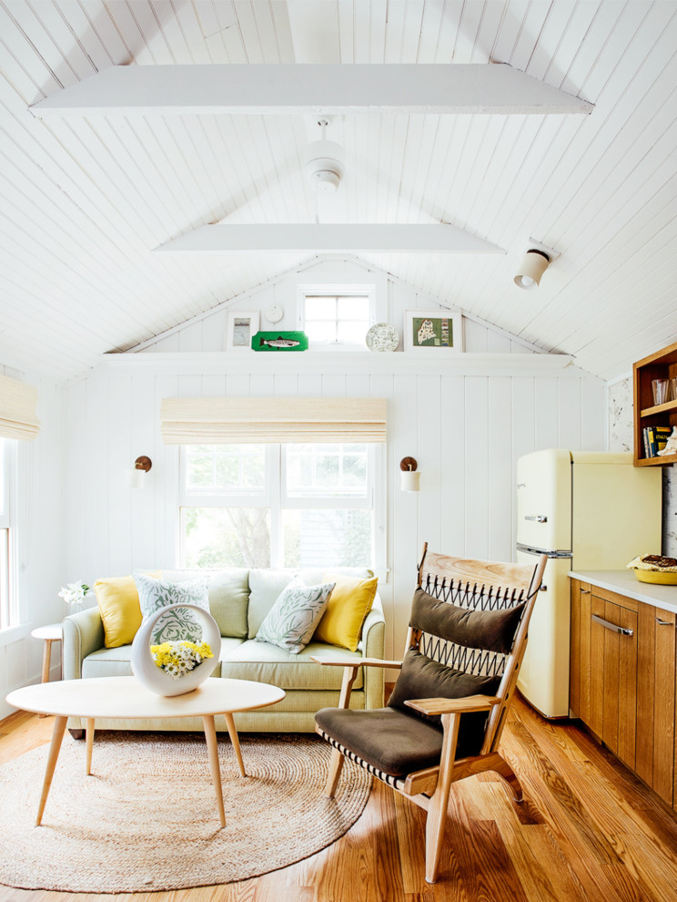 Small beach style open concept medium tone wood floor living room photo in Portland Maine with white walls