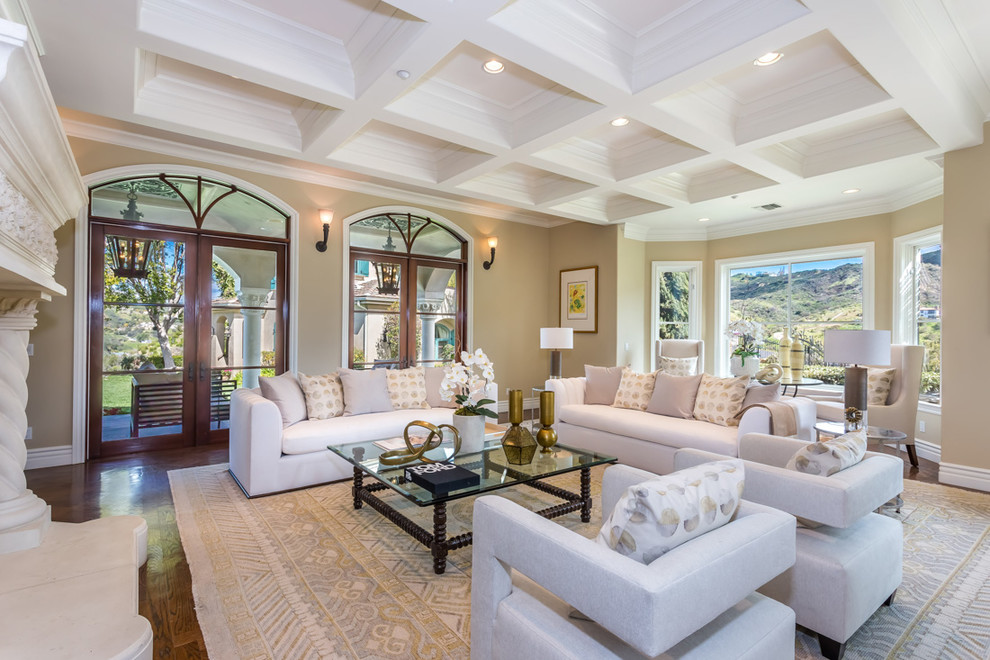 Example of a tuscan formal medium tone wood floor living room design in Los Angeles with beige walls