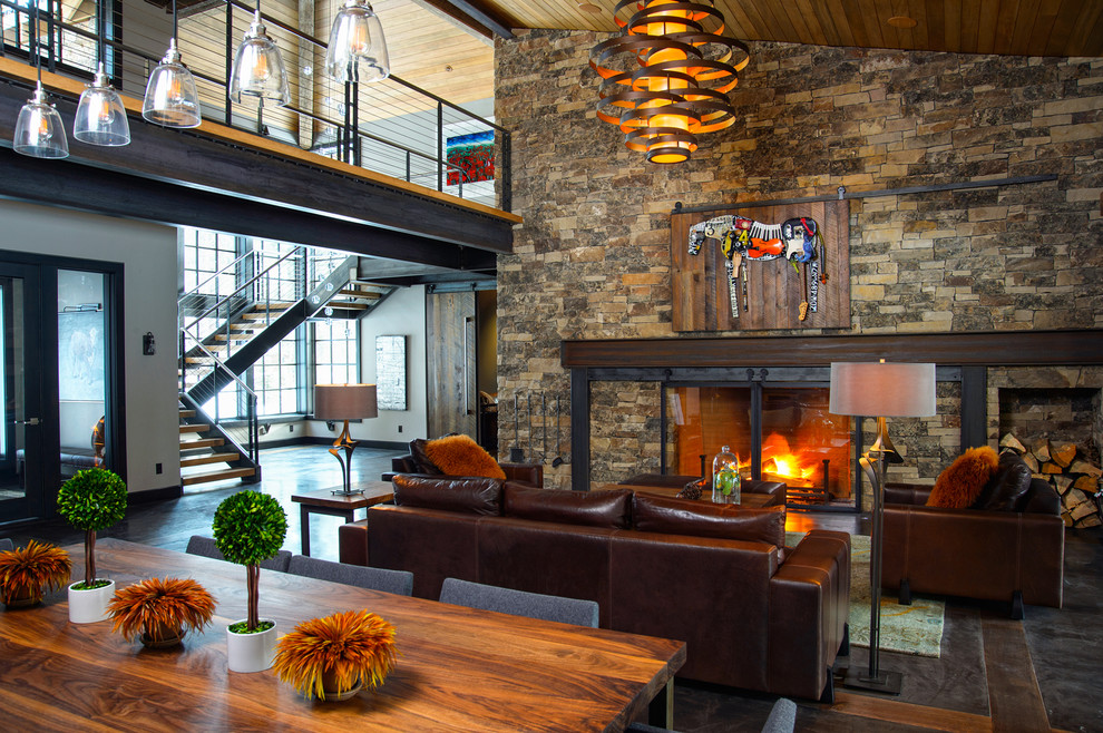 Trendy formal and open concept concrete floor living room photo in Portland with gray walls, a standard fireplace, a stone fireplace and no tv