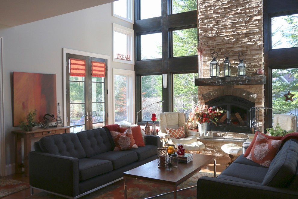 This is an example of a large classic living room with beige walls, medium hardwood flooring, a standard fireplace and a stone fireplace surround.