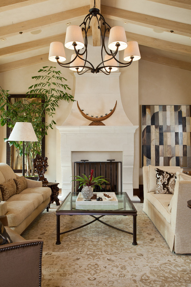Inspiration for a large mediterranean formal and open concept dark wood floor living room remodel in San Francisco with beige walls, a standard fireplace, a stone fireplace and no tv