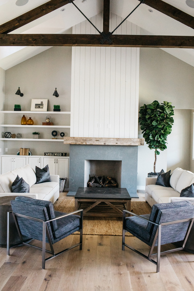 Inspiration for a country open concept light wood floor living room remodel in Phoenix with gray walls, a standard fireplace, a stone fireplace and no tv