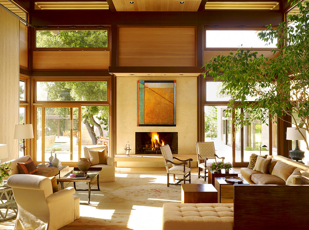 Expansive contemporary open plan living room in San Francisco with beige walls, a standard fireplace, carpet, a tiled fireplace surround, no tv and beige floors.