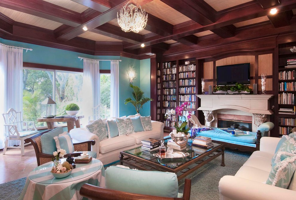 Mid-sized beach style enclosed carpeted and gray floor living room library photo in Miami with blue walls, a standard fireplace, a stone fireplace and a wall-mounted tv