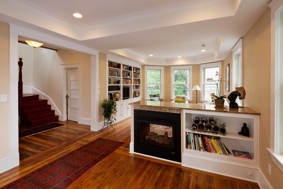 Mid-sized elegant open concept medium tone wood floor living room photo in Boston with beige walls and a two-sided fireplace