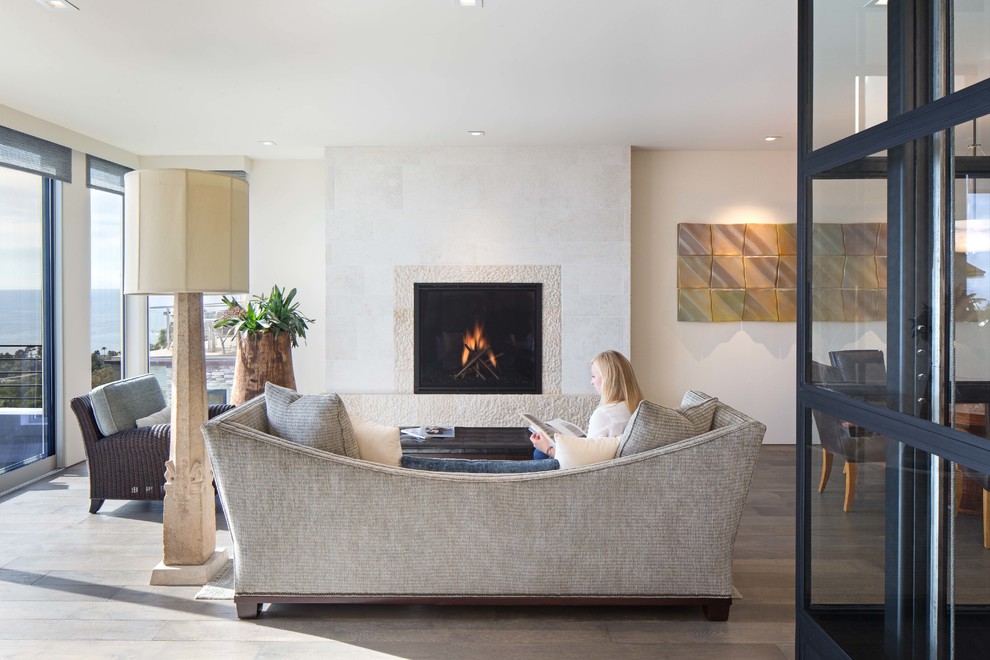 Photo of a medium sized contemporary formal open plan living room in Orange County with white walls, dark hardwood flooring, a standard fireplace, a stone fireplace surround and no tv.