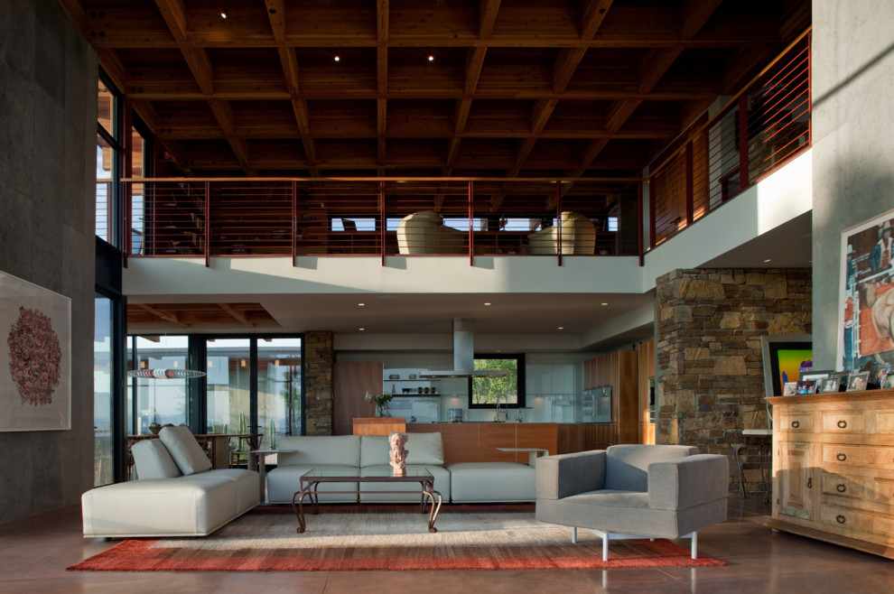 This is an example of an expansive contemporary formal open plan living room in Phoenix with concrete flooring and brown floors.