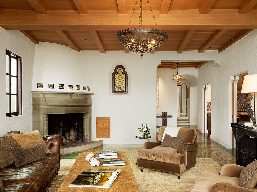 Photo of a large mediterranean formal enclosed living room in San Francisco with white walls, terracotta flooring, a corner fireplace and a stone fireplace surround.