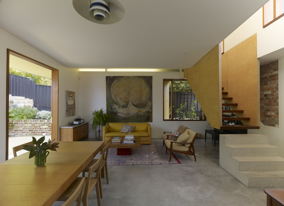 Inspiration for a contemporary concrete floor living room remodel in Sydney with white walls