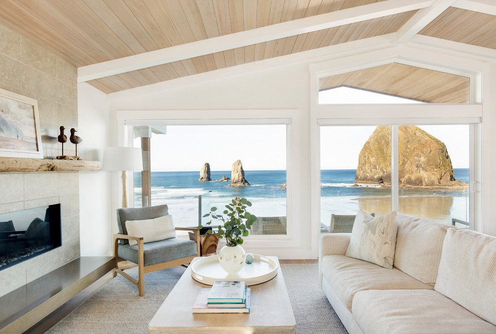 Example of a beach style open concept medium tone wood floor living room design in Seattle with white walls, a ribbon fireplace and a tile fireplace