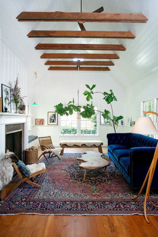 Living room - mid-sized cottage enclosed medium tone wood floor living room idea in Los Angeles with white walls and a standard fireplace