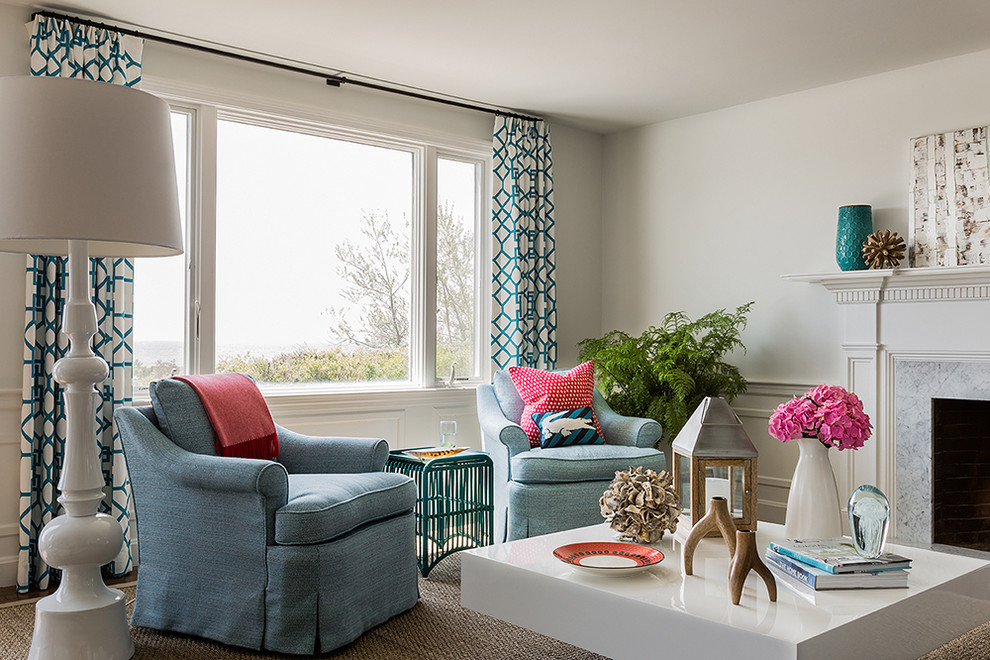 На фото: гостиная комната в современном стиле с бежевыми стенами, стандартным камином и синими шторами с