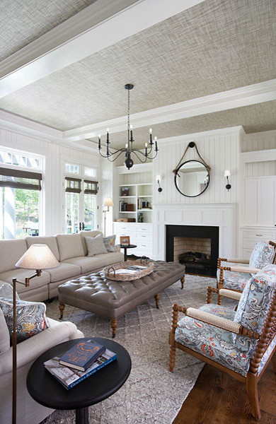 Cette photo montre un salon ouvert avec un mur blanc, un sol en bois brun, une cheminée standard, un manteau de cheminée en bois, un téléviseur dissimulé et un sol marron.