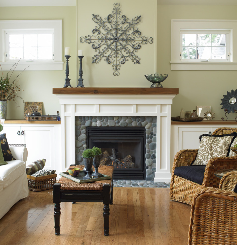 Inspiration for a timeless medium tone wood floor living room remodel in Vancouver with beige walls and a standard fireplace