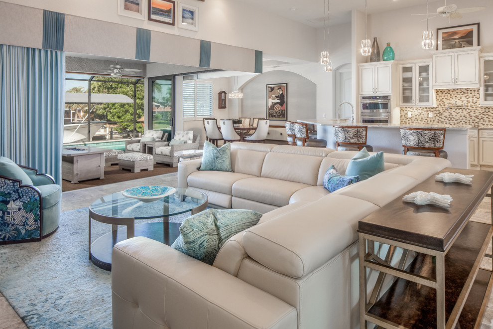Beach style open plan living room in Miami with white walls and grey floors.