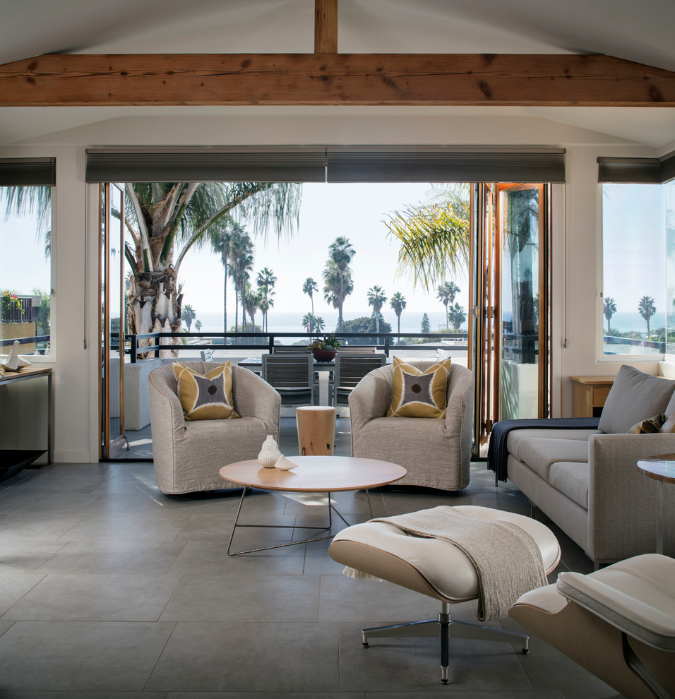 Example of a beach style gray floor living room design in San Diego with white walls