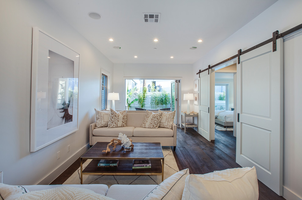 Example of a beach style formal dark wood floor living room design in Los Angeles with white walls and no tv