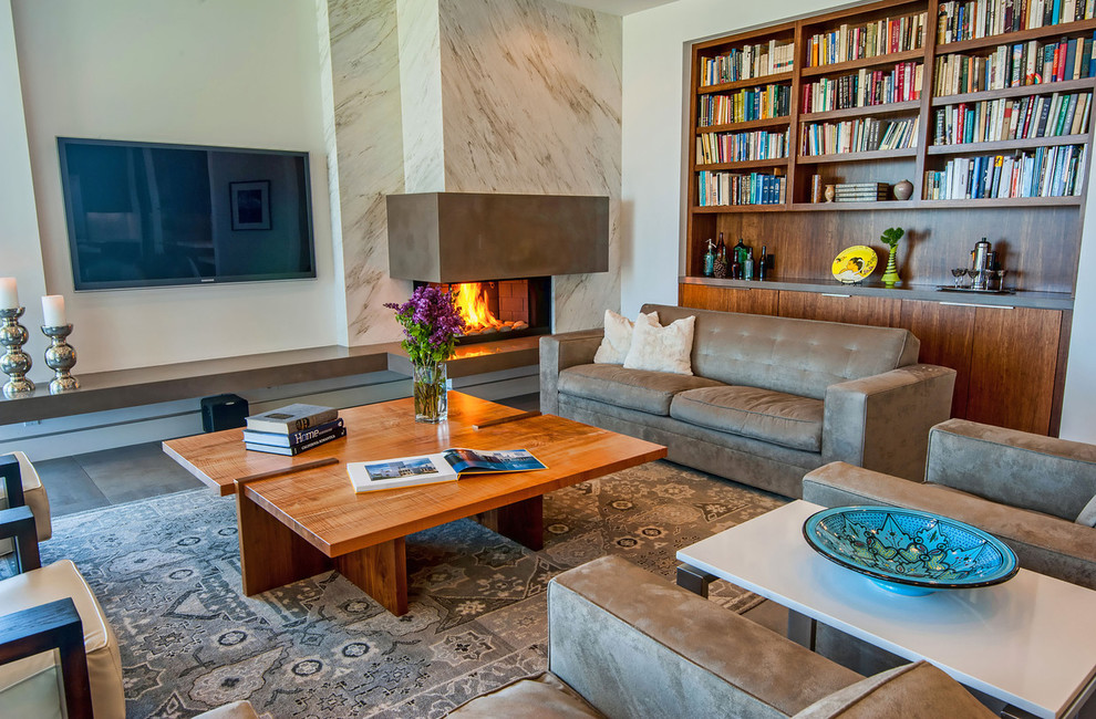 This is an example of a contemporary living room in Los Angeles with a corner fireplace.