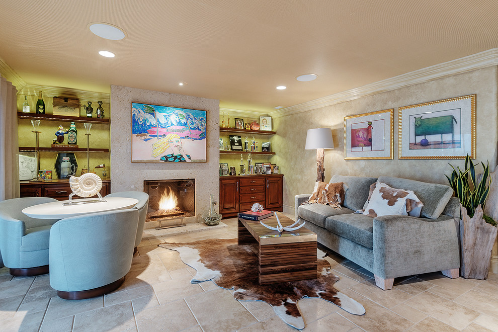 Large island style formal and enclosed travertine floor and beige floor living room photo in Los Angeles with beige walls, a standard fireplace and a stone fireplace
