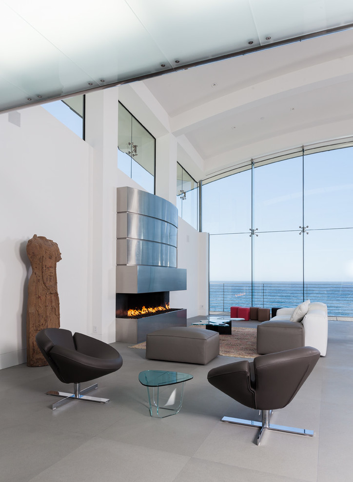 This is an example of a large modern open plan living room in San Francisco with white walls, concrete flooring, a standard fireplace and a metal fireplace surround.