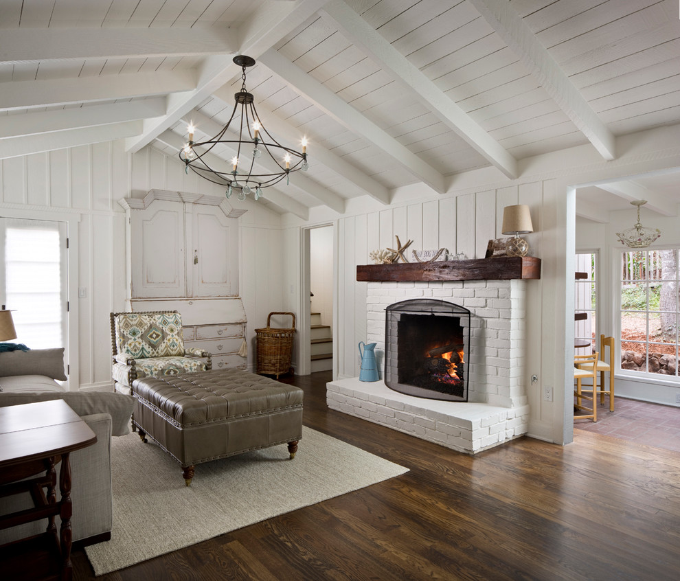 This is an example of a medium sized traditional formal open plan living room in Other with white walls, dark hardwood flooring, a standard fireplace, a stone fireplace surround, no tv and brown floors.