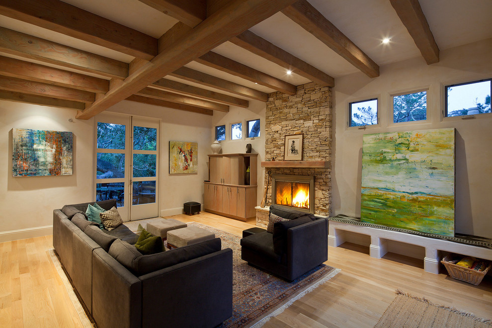 This is an example of a contemporary living room in San Francisco with a stone fireplace surround.