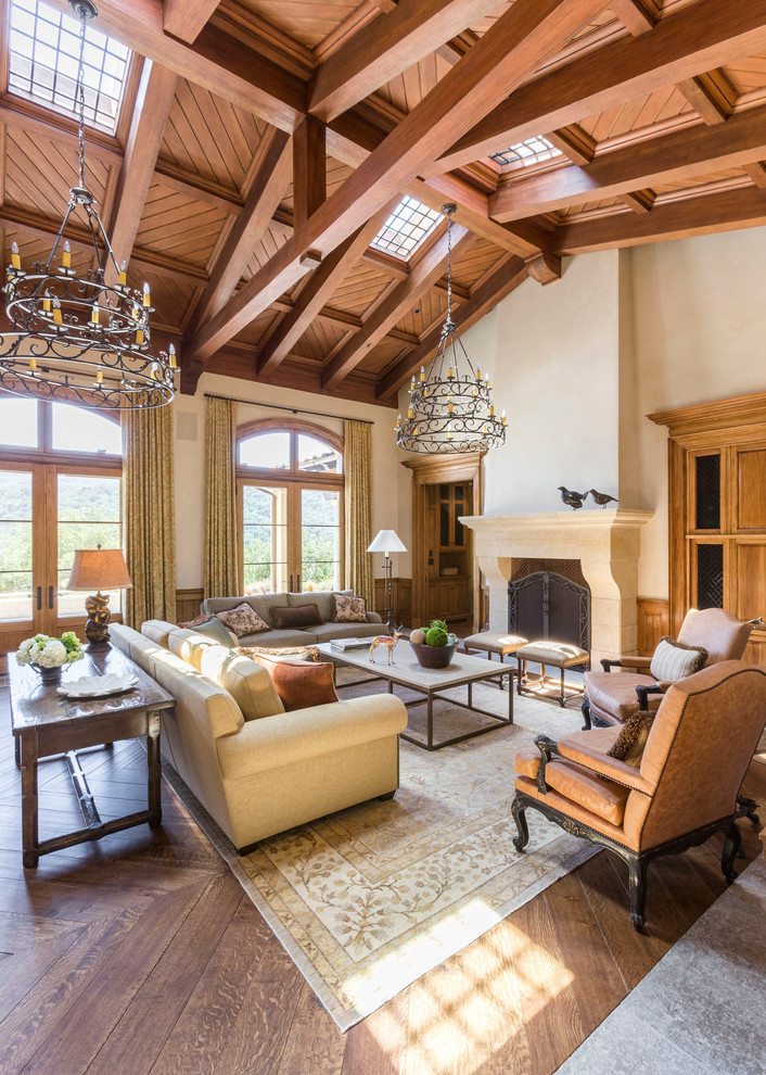 Living room - huge mediterranean formal and open concept medium tone wood floor and brown floor living room idea in San Francisco with beige walls, a standard fireplace, a stone fireplace and no tv
