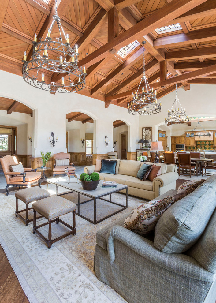 Example of a large tuscan formal and open concept dark wood floor and brown floor living room design in San Francisco with white walls, no fireplace and no tv