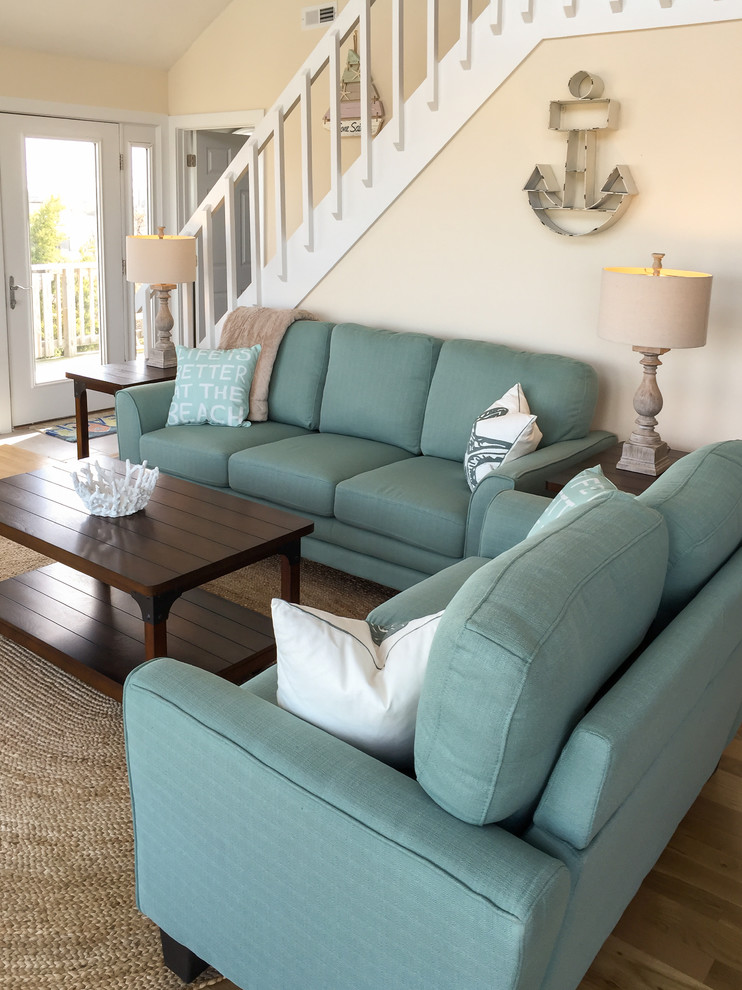 Inspiration for a mid-sized coastal open concept vinyl floor living room remodel in Other with beige walls, a corner fireplace and a wood fireplace surround
