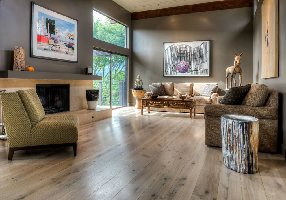 Inspiration for a medium sized contemporary formal enclosed living room in Sacramento with grey walls, light hardwood flooring, a standard fireplace and a stone fireplace surround.